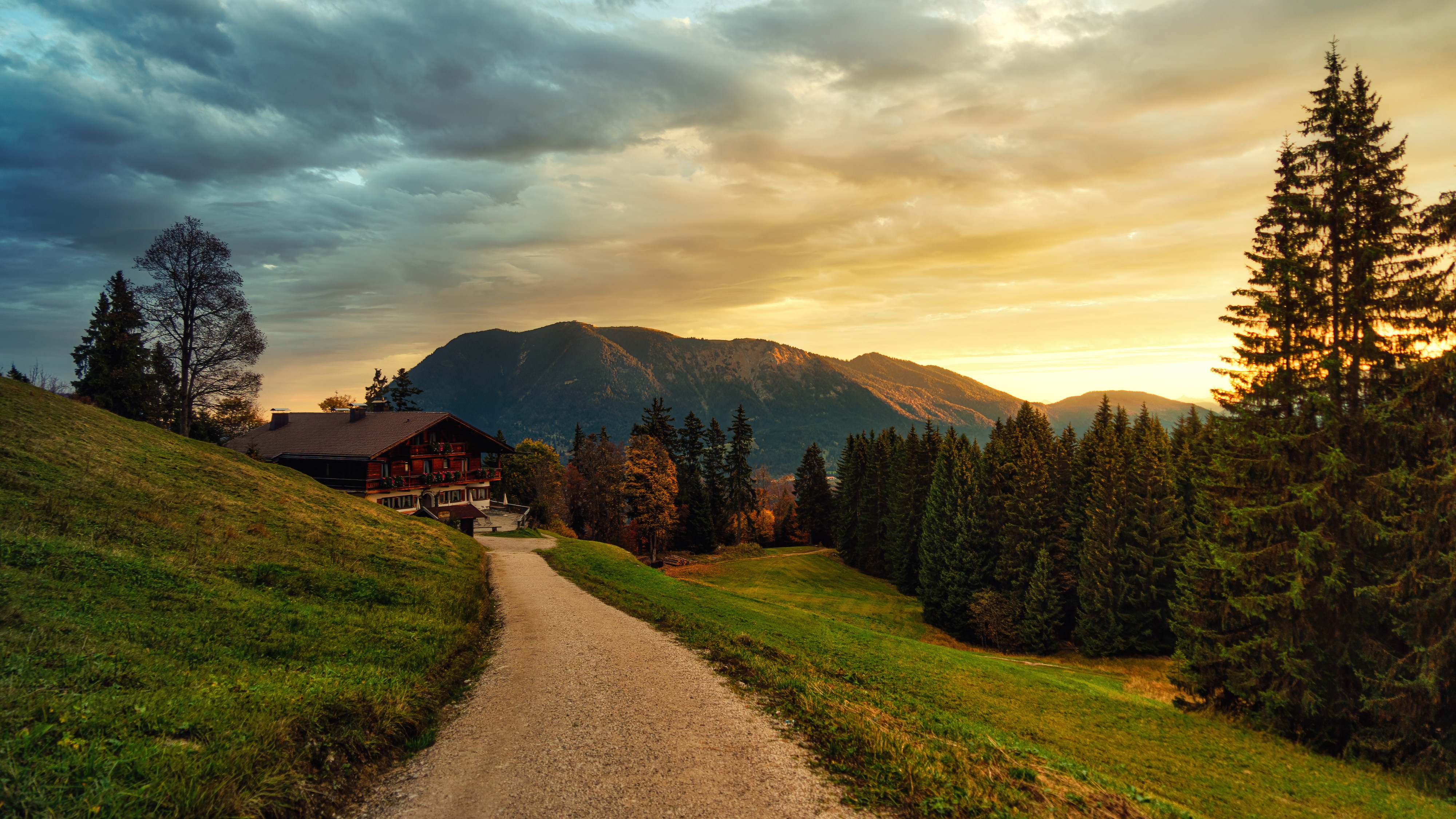 Path leading to a building with mountains